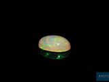 a white oplite in the dark with a green light