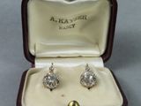 a pair of earrings that are in a box