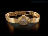 an image of a gold wrist watch on a black background