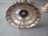 a silver vase with a tag on it on a table