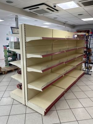 empty shelves in the middle of a store that is empty