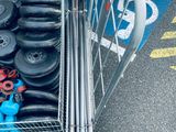 a basket full of tires and other items in front of a car