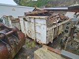 a dumpster that is sitting next to a pile of junk