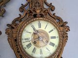 two clocks that are on the wall next to each other