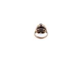a close up of a gold ring with a black and white diamond