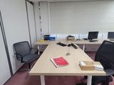 an image of an empty office with a desk and chairs