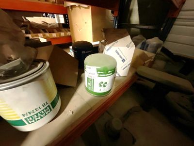 a bucket of paint sitting on a shelf next to a can of paint