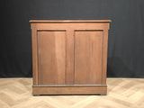 an image of a wooden cabinet on a parquet floor