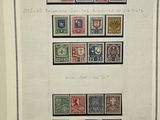 a framed picture of a collection of stamps on a table