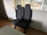 two black seats sitting next to each other in a room