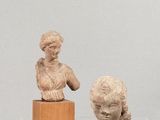 des sculptures représentant une femme et un enfant exposées dans une vitrine
