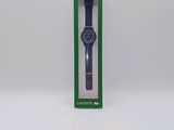 a close up of a watch in a green box on a white surface