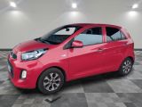 a red car is parked in a room with a checkered floor