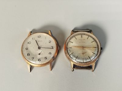 two watches sitting next to each other on a table
