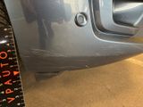 a close up of a car ' s front bumper with a measuring tape