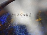 a close up of a blue vase with writing on it