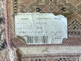 a ticket that is sitting on top of a rug