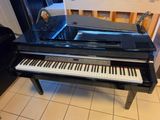 a piano that is sitting on the floor in the room