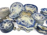 many blue and white plates and bowls on the table
