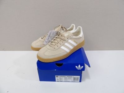 adidas gazelle trainers in beige and white on a blue box