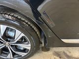 a close up of a tire on a car in a garage