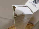 a cardboard box with a piece of paper sticking out of it