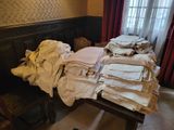 a table with a lot of folded clothes on top of it