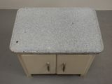a small table with two drawers on top of it