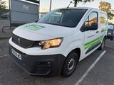 a white van parked in a parking lot with other cars