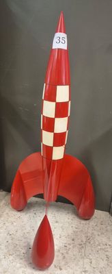 a red and white rocket shaped object on a table