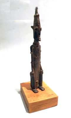 statue of a person sitting on a wooden block with a white background