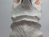 a white cat statue that is sitting on a table