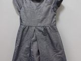 a little girl ' s dress hanging on a hanger