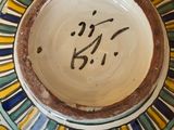 a ceramic bowl with writing on it sitting on a table