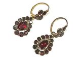 an image of a pair of earrings with garnets on them