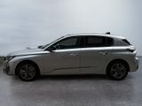 the silver car is parked on the concrete floor in the room