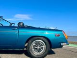 a blue car that is parked on the side of the road