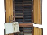 a wooden cabinet with a painting on it and a easel