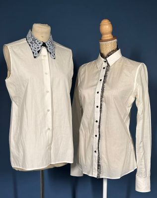 two mannequins with shirts and ties on display against a blue wall