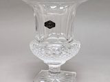 a clear glass vase with a black label on it