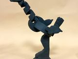 a sculpture of a bird that is on a stand