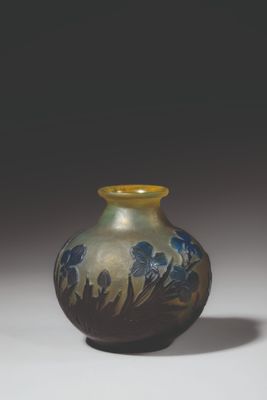 a blue and yellow vase sitting on a white surface