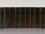 several books are lined up in a row on a white surface
