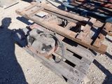 a wooden pallet sitting on the ground next to a pile of wood
