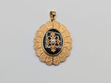 un pendentif en or orné d'un médaillon en noir et blanc