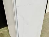 a white refrigerator that is sitting on the floor