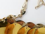 a close up of a gold plated necklace with a star on it