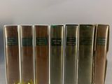 several books are lined up in a row on a table