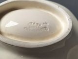 a white vase that has a lid on it