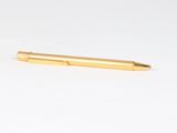 a close up of a pen laying on a white surface